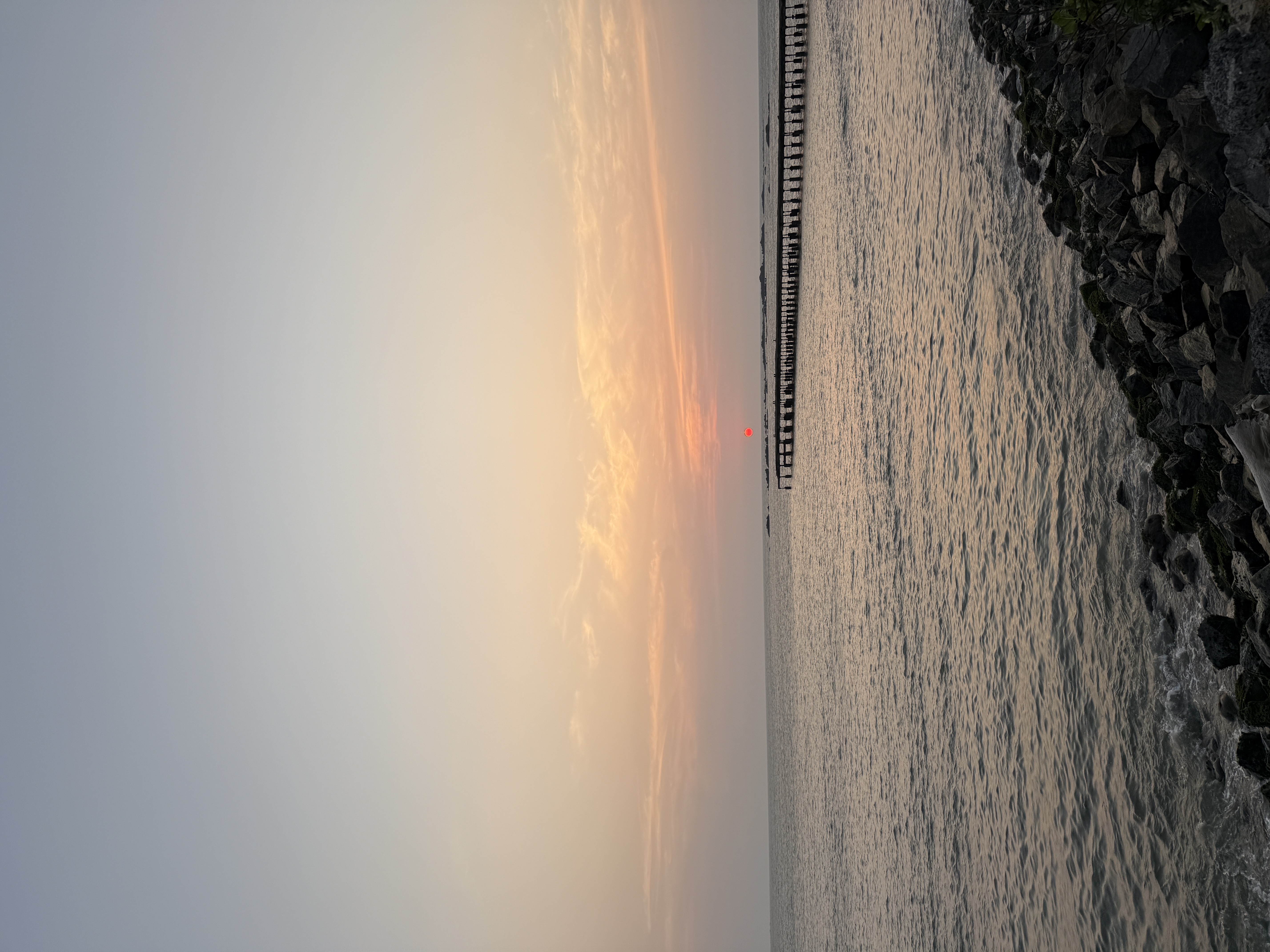 Sunset view at Muzhappilangad Beach with rocky shoreline and sea waves